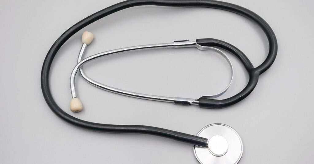 A stethoscope on a gray background