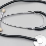 A stethoscope on a gray background