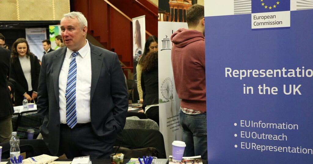 Exhibitors and job seekers at a career fair