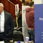 Exhibitors and job seekers at a career fair