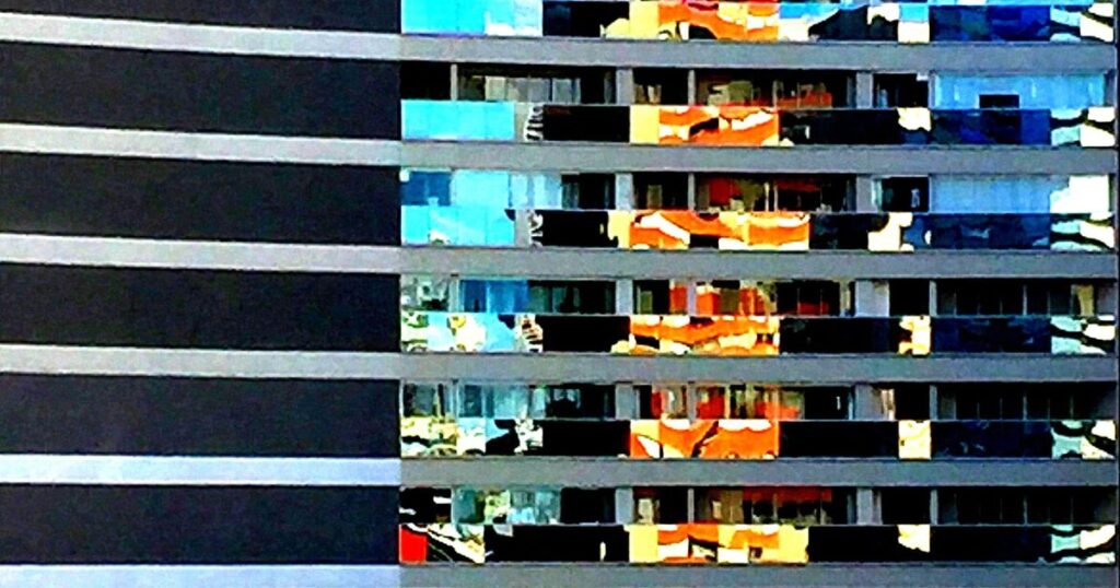 Colorful reflections across the windows of an office tower